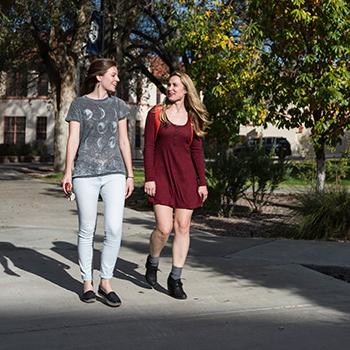 Two students walking on campus